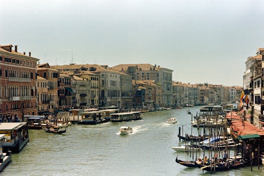 Picturesque view of Venice's famous canal with gondolas and historic buildings.