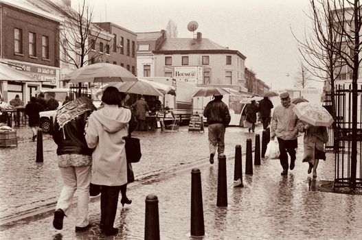 People Walking on the Street in Rain in Sepia