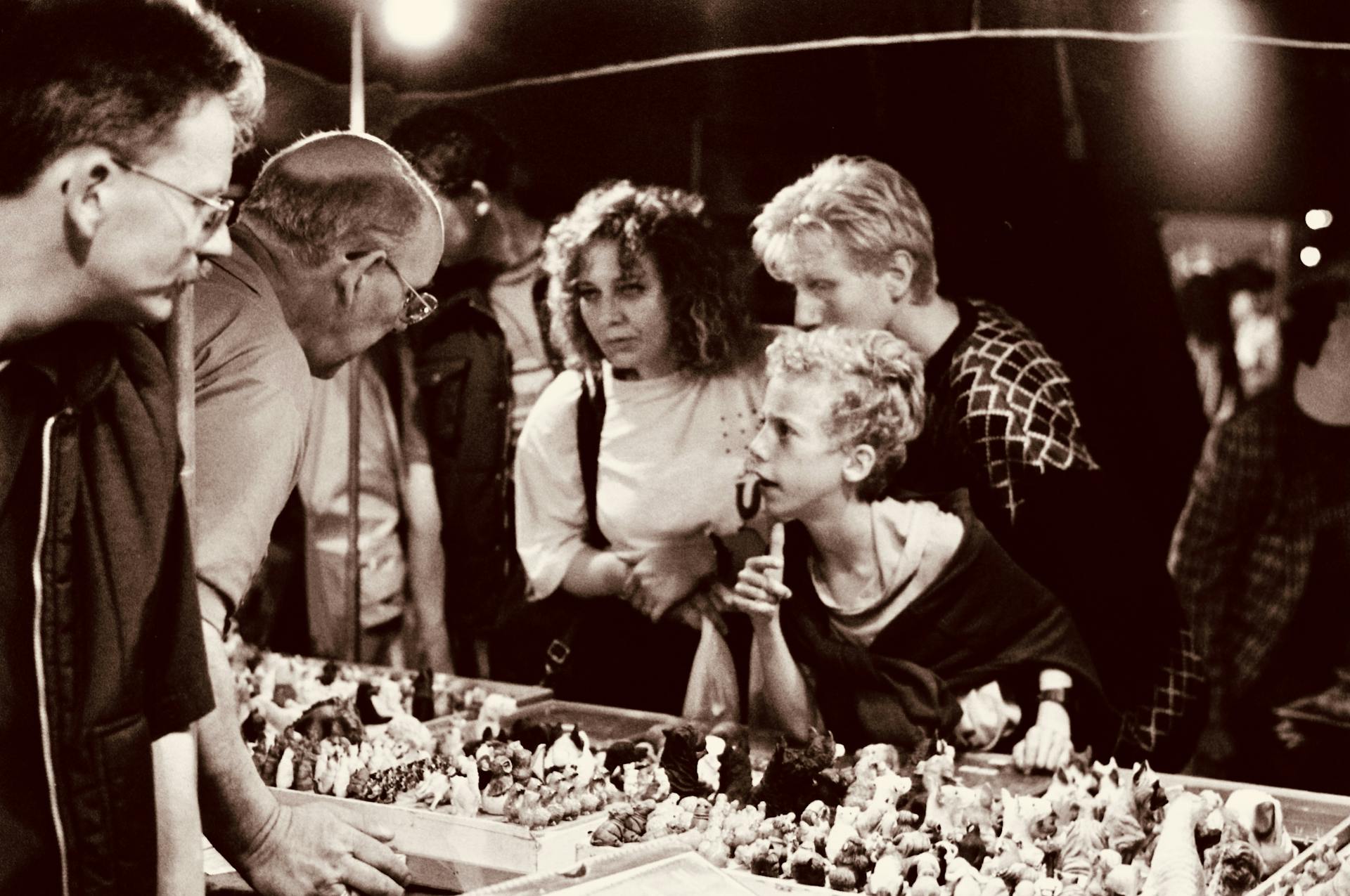 Sepia Photo of a Group of People at a Stall at a Flea Market