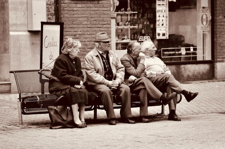 Elderly People Sitting On Urban Bench