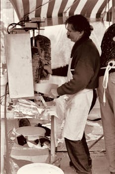 Vendor slices meat at a market stall, capturing the essence of street food culture.