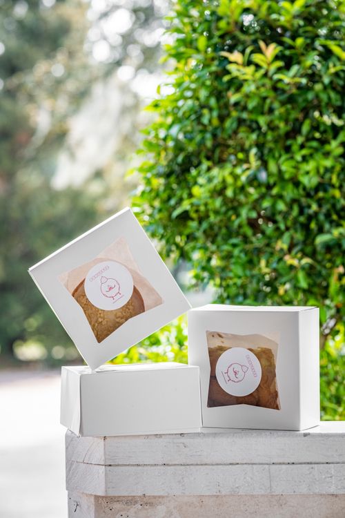 Free Three white boxes with donuts, displayed outdoors on a stone ledge. Stock Photo