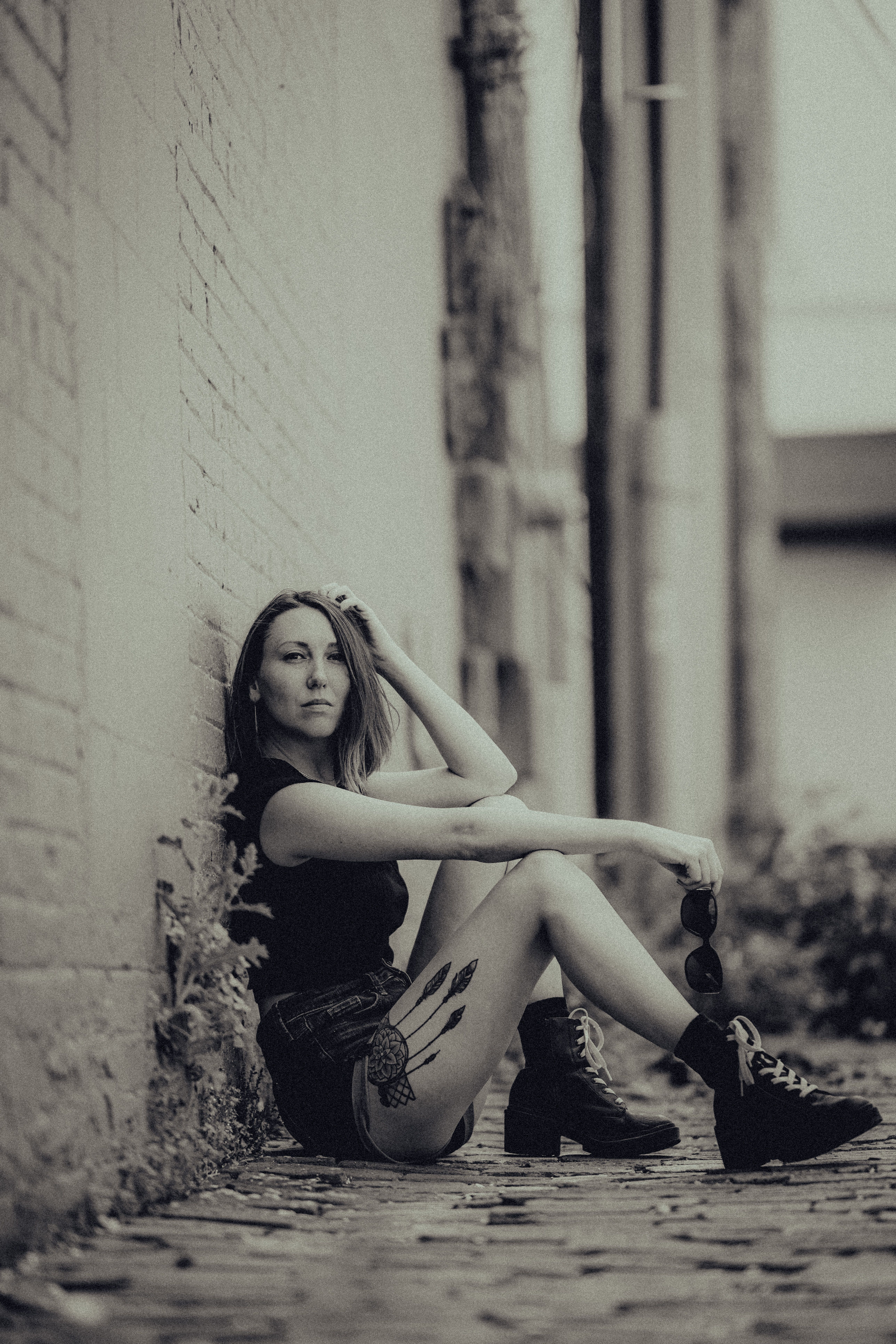 Woman Sitting on Side Urban Street