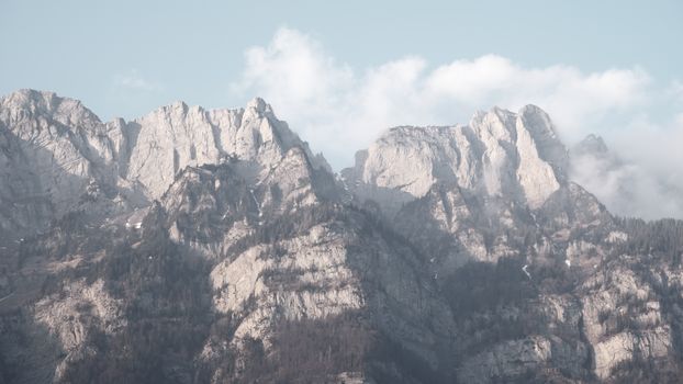 Scenic view of the Swiss Alps with majestic peaks under a winter sky in St. Gallen, Switzerland.