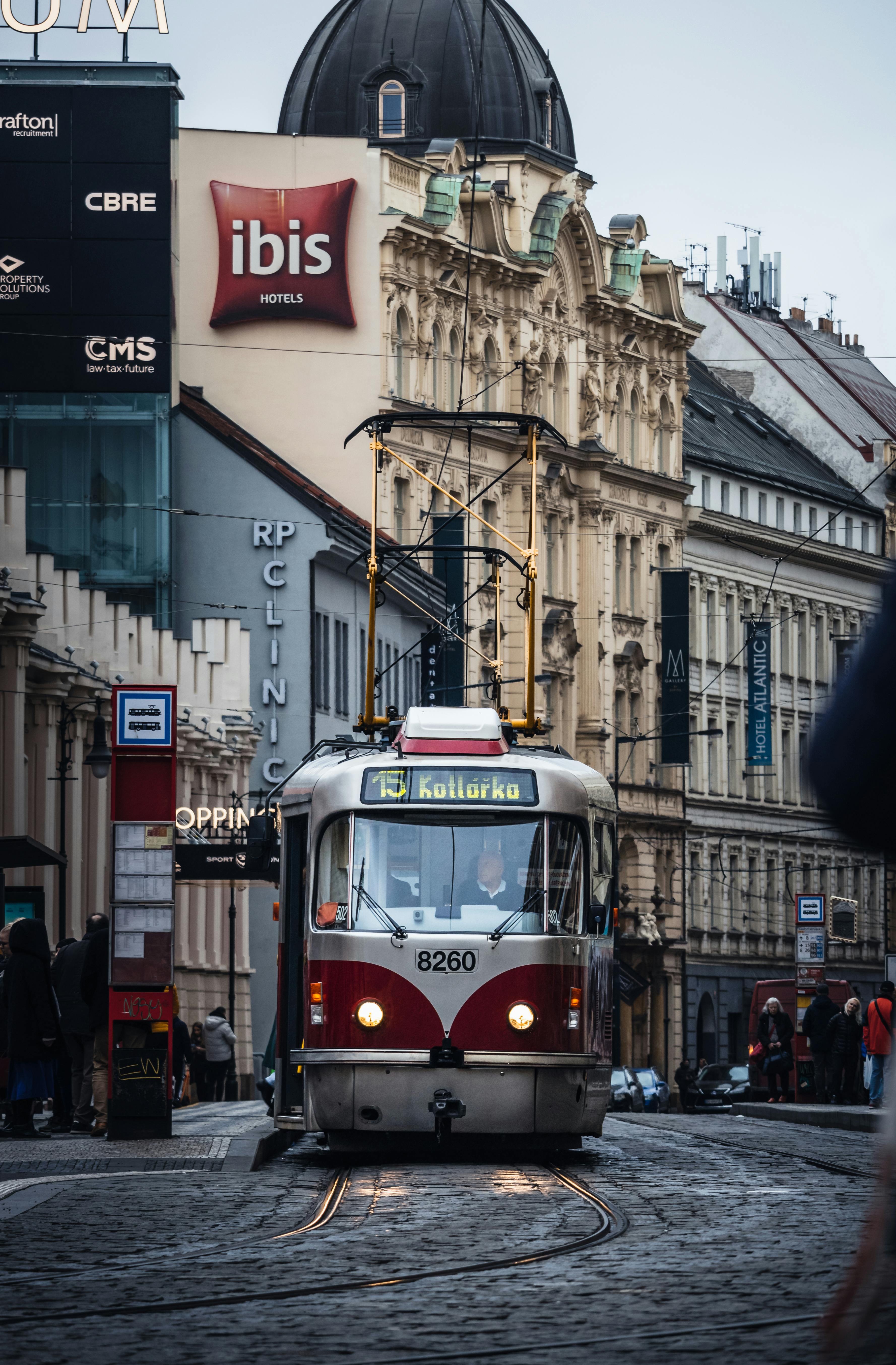 a red and white tram on a city street