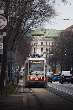 A tram moving through the streets of Vienna on a chilly winter day, showcasing urban transportation.