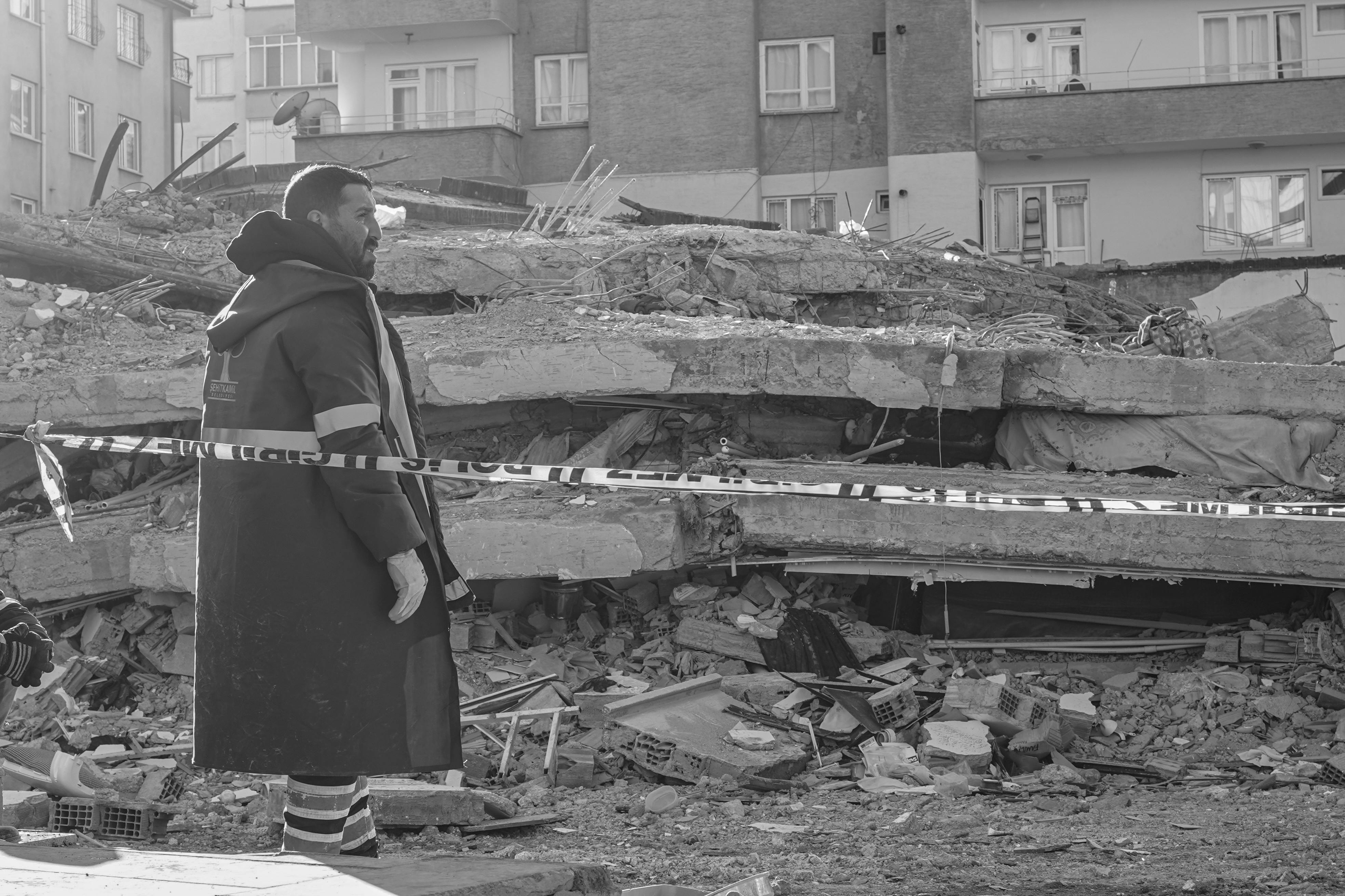 A man surveys the urban ruins after a devastating earthquake in Gaziantep, Turkey.