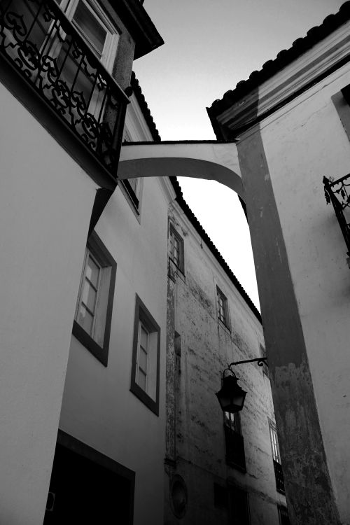 Free Black and white photo capturing the architecture of an old town alley. Stock Photo