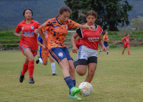 Teenage Girls Playing Football