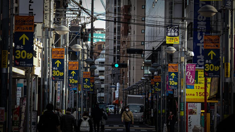 Advertisements And Power Lines Around Street In City