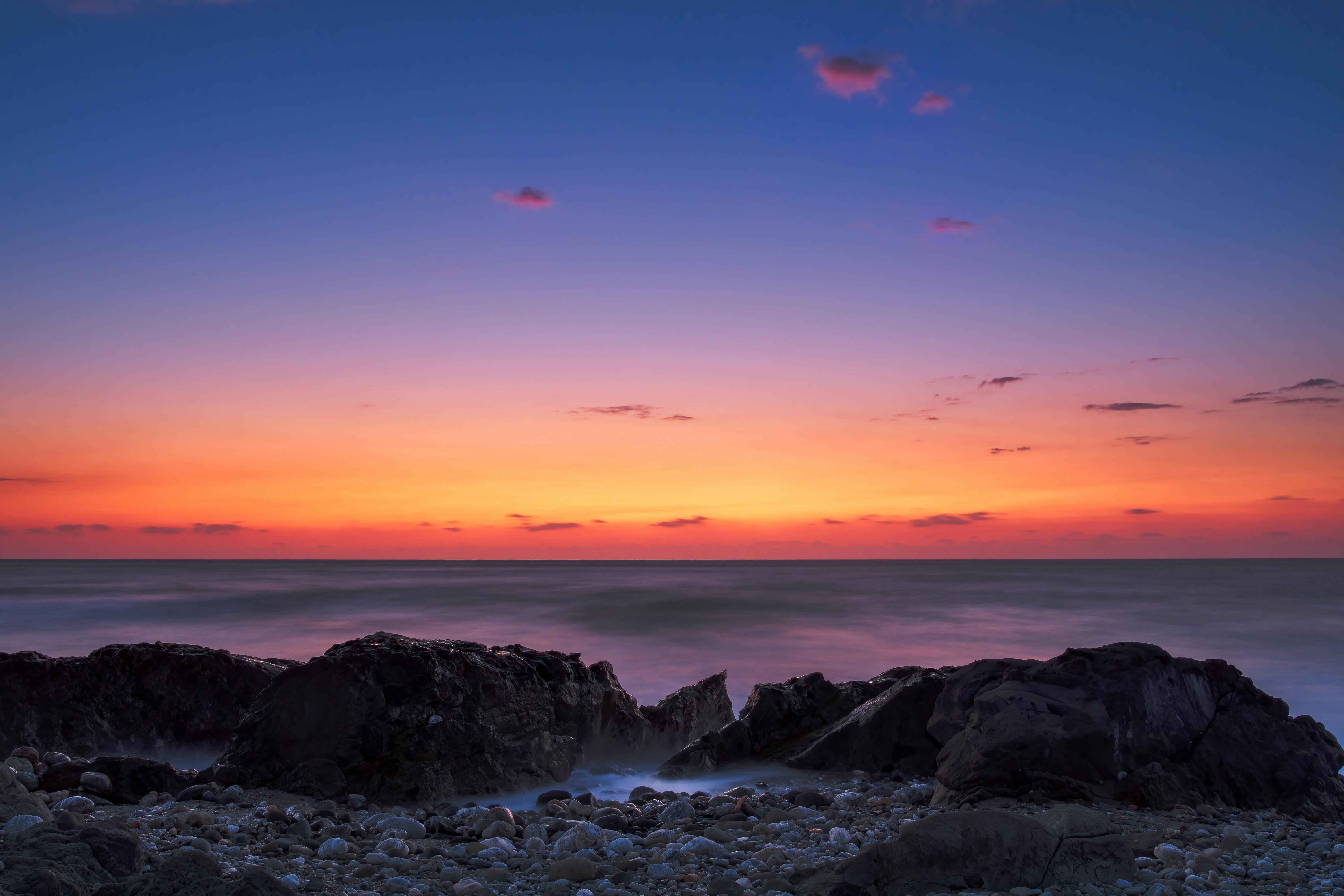 Beautiful sunset seascape with rocky beach and vibrant red sky in Hualien, Taiwan
