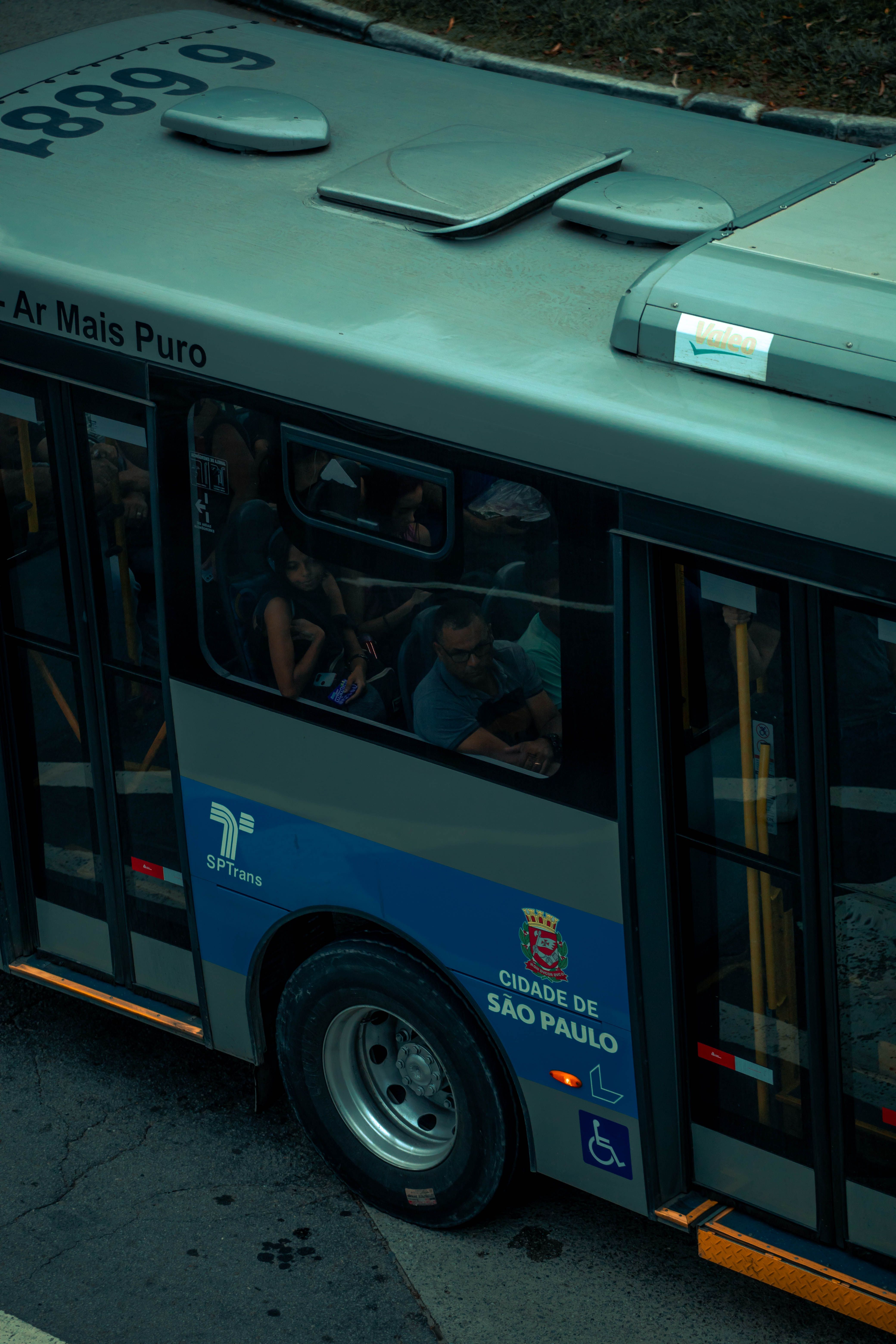 A high angle view of a public bus in São Paulo, Brazil, showing commuters inside.