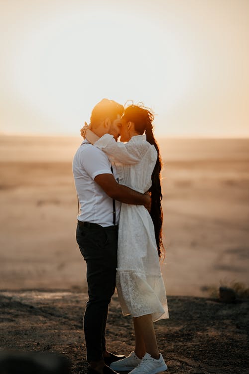 Couple Kissing on Beach at Sunset