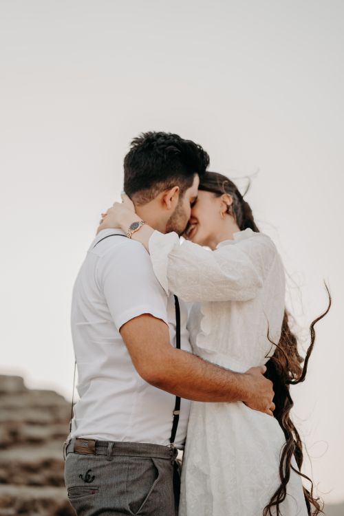 Free A loving couple embraces during sunset, showcasing romance and emotion. Stock Photo