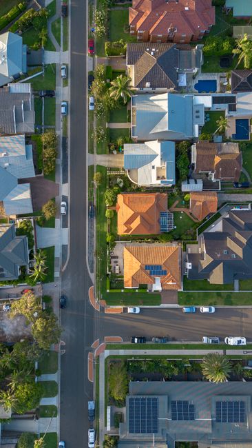Aerial photo of suburban street and houses in Collaroy, NSW, showcasing colorful rooftops and greenery.