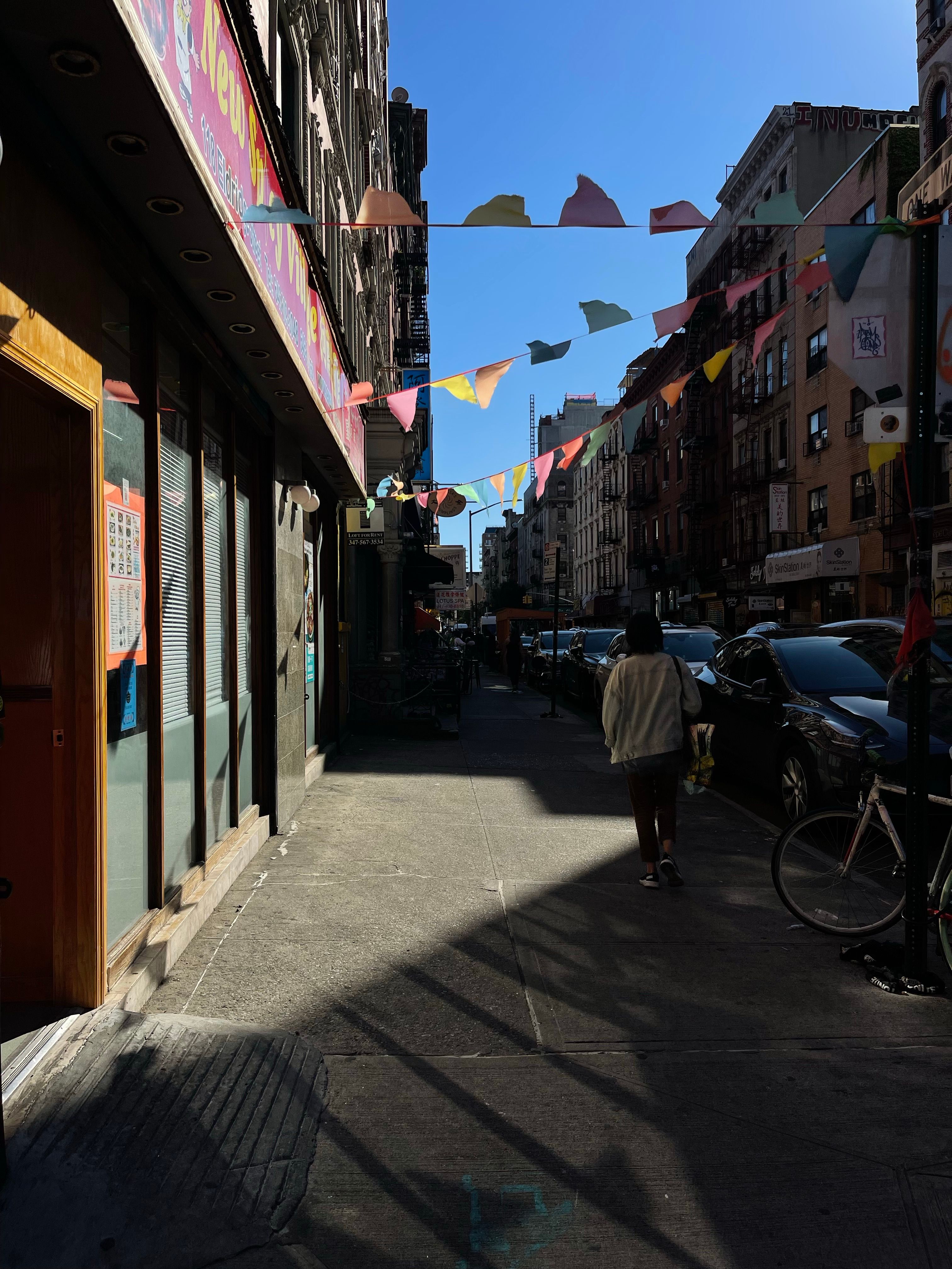 Flags Hanging between Buildings on City Street · Free Stock Photo