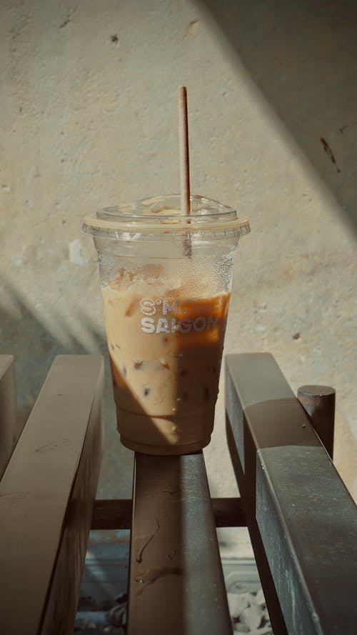 Close-up of an Iced Coffee in a Plastic Cup with a Straw 