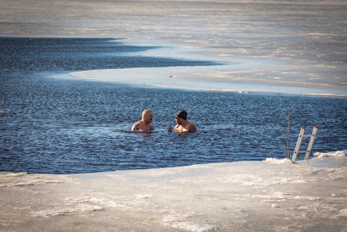 Two people swimming in an ice hole - photo by Olavi Anttila on Pexels