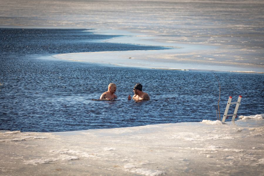 Two people cold plunging in icy water — cold water immersion practice growing in popularity