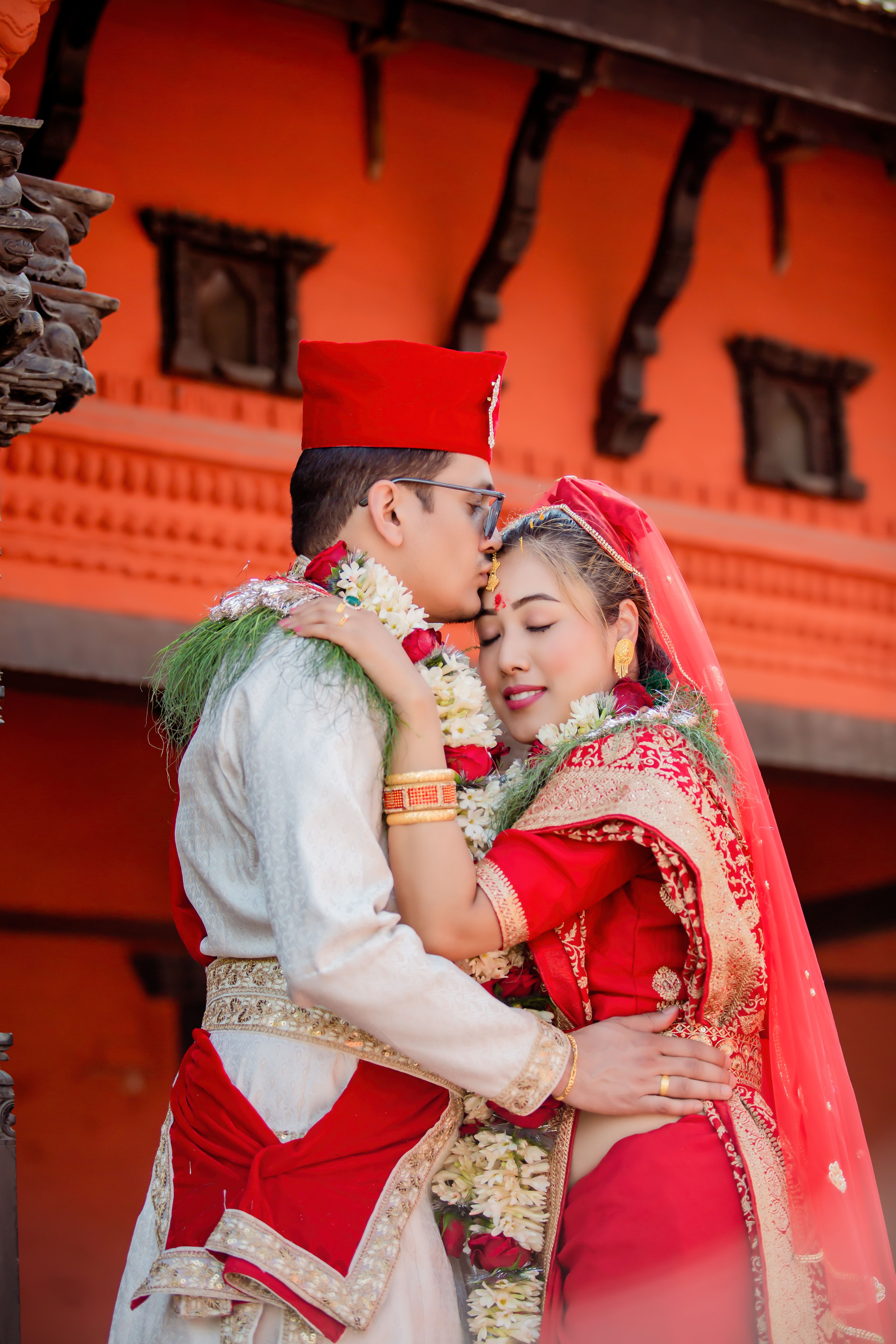 Couple in Traditional Clothing Hugging and Kissing · Free Stock Photo