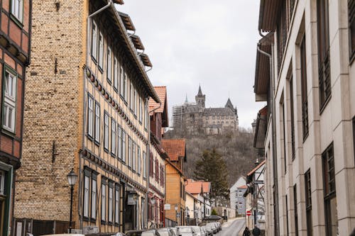View of an Old Town Street with Historical Buildings and the Wernigerode Castle on a Hill in Wernigerode, Germany 
