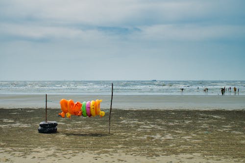 Clouds over Sea Shore with Toys on Beach