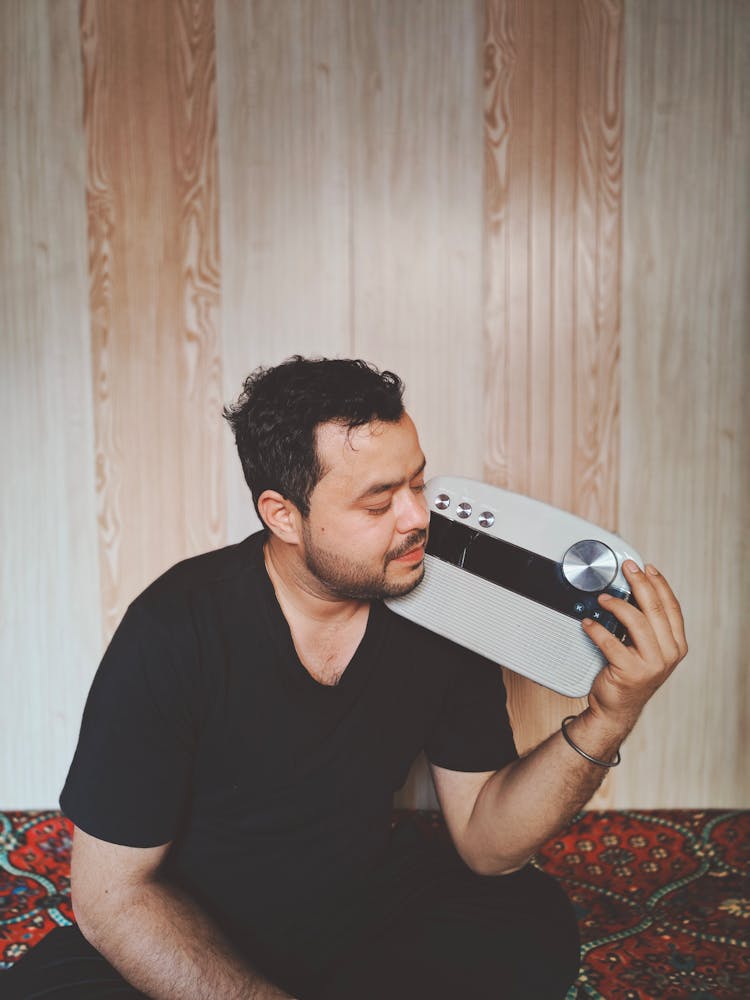 Man Holding A Radio And Listening To The Music 