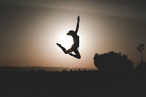 Silhouette Of Person While Jumping