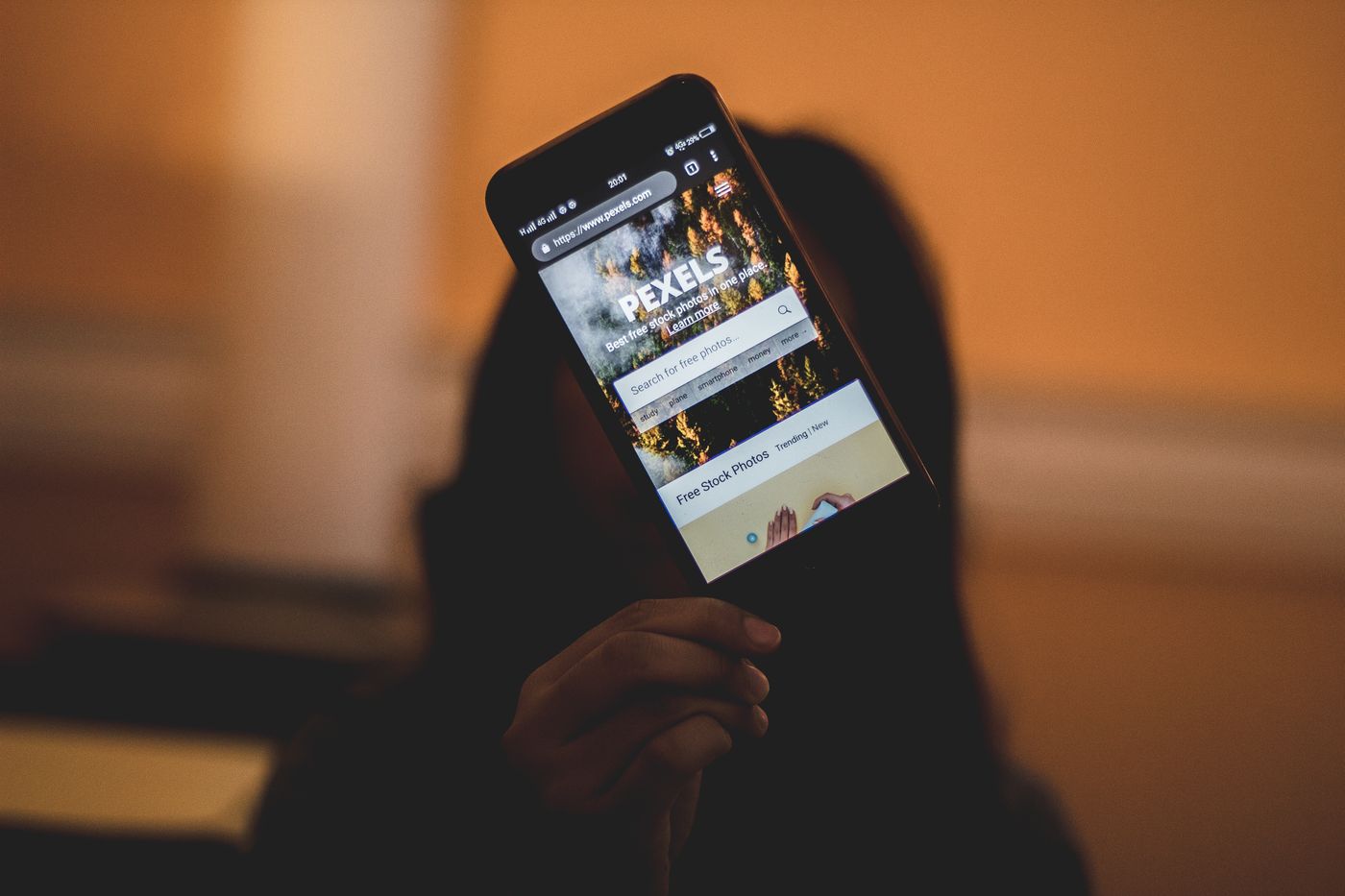 Person holding a smartphone while checking messages and device information