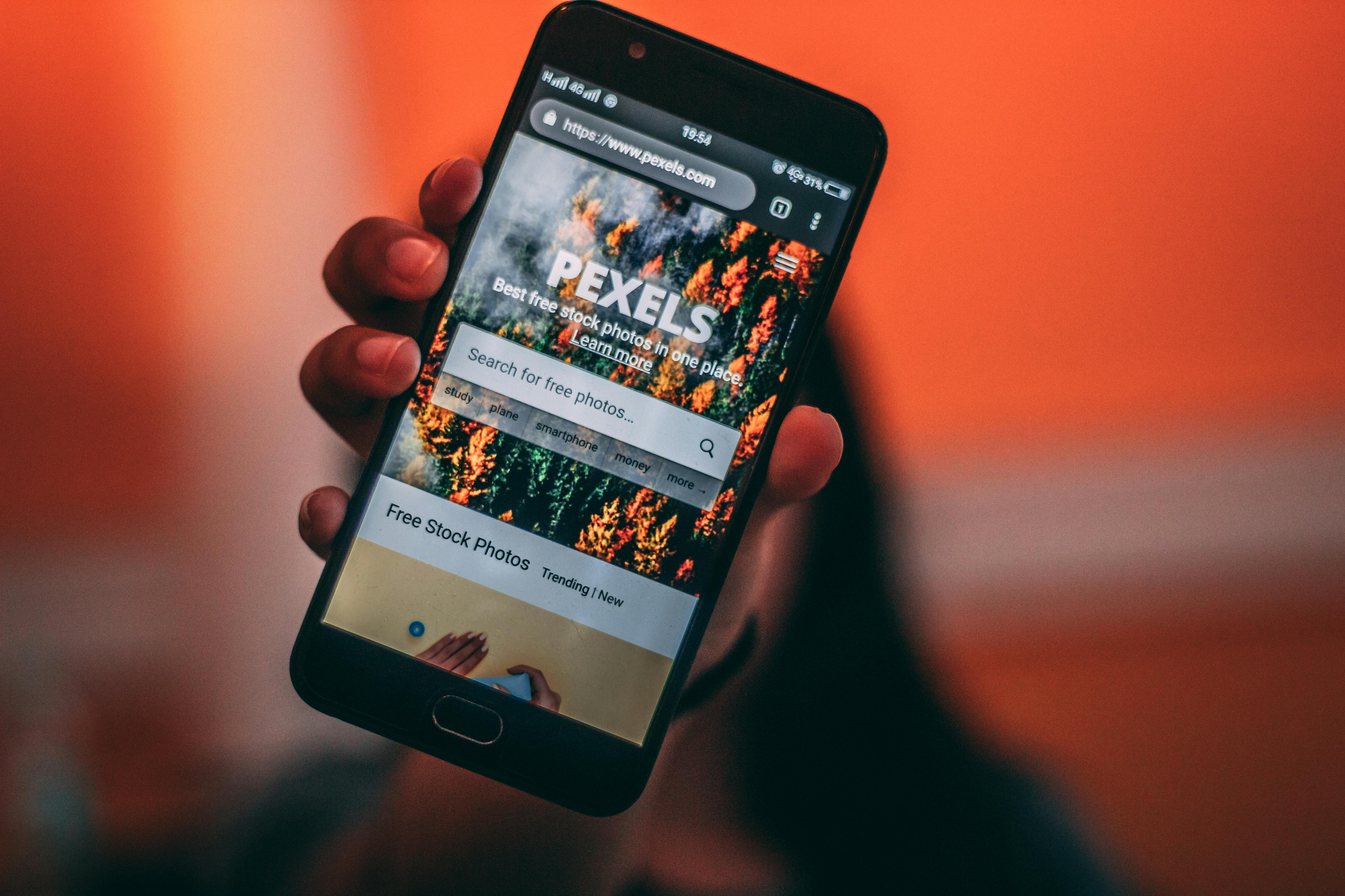 Person Holding Black Smartphone