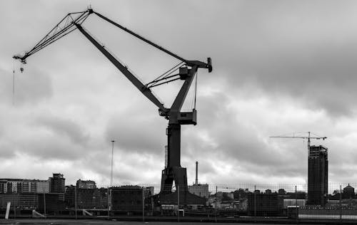 View of a Shipyard Crane in City under a Cloudy Sky 