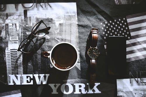 White and Brown Mug Beside Brown Watch