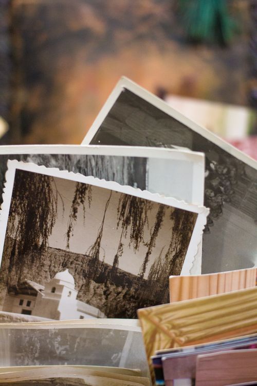 Free Close-up of a stack of vintage photographs displaying historic scenes. Stock Photo