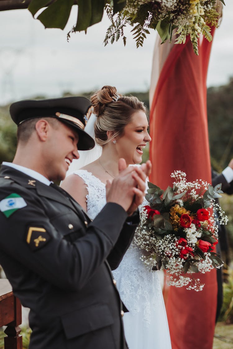 Newlyweds In Uniform And Wedding Dress