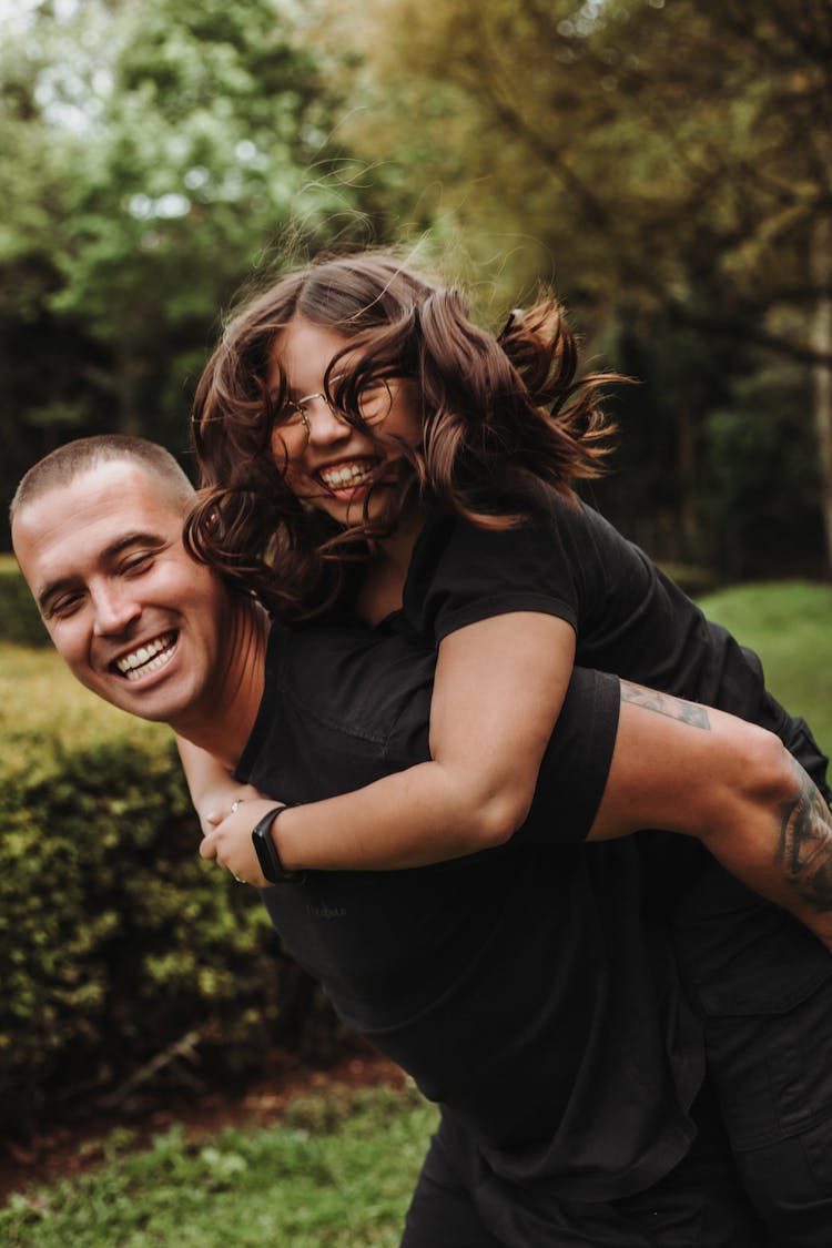 Man Carrying A Girl On His Back 