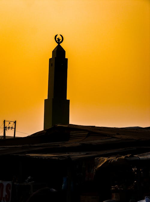 Silhouette of the Monument Against the Golden Sky at Sunset