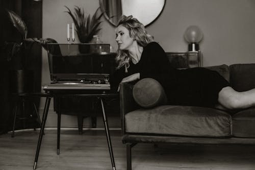 Elegant Woman Lying on Sofa at Home