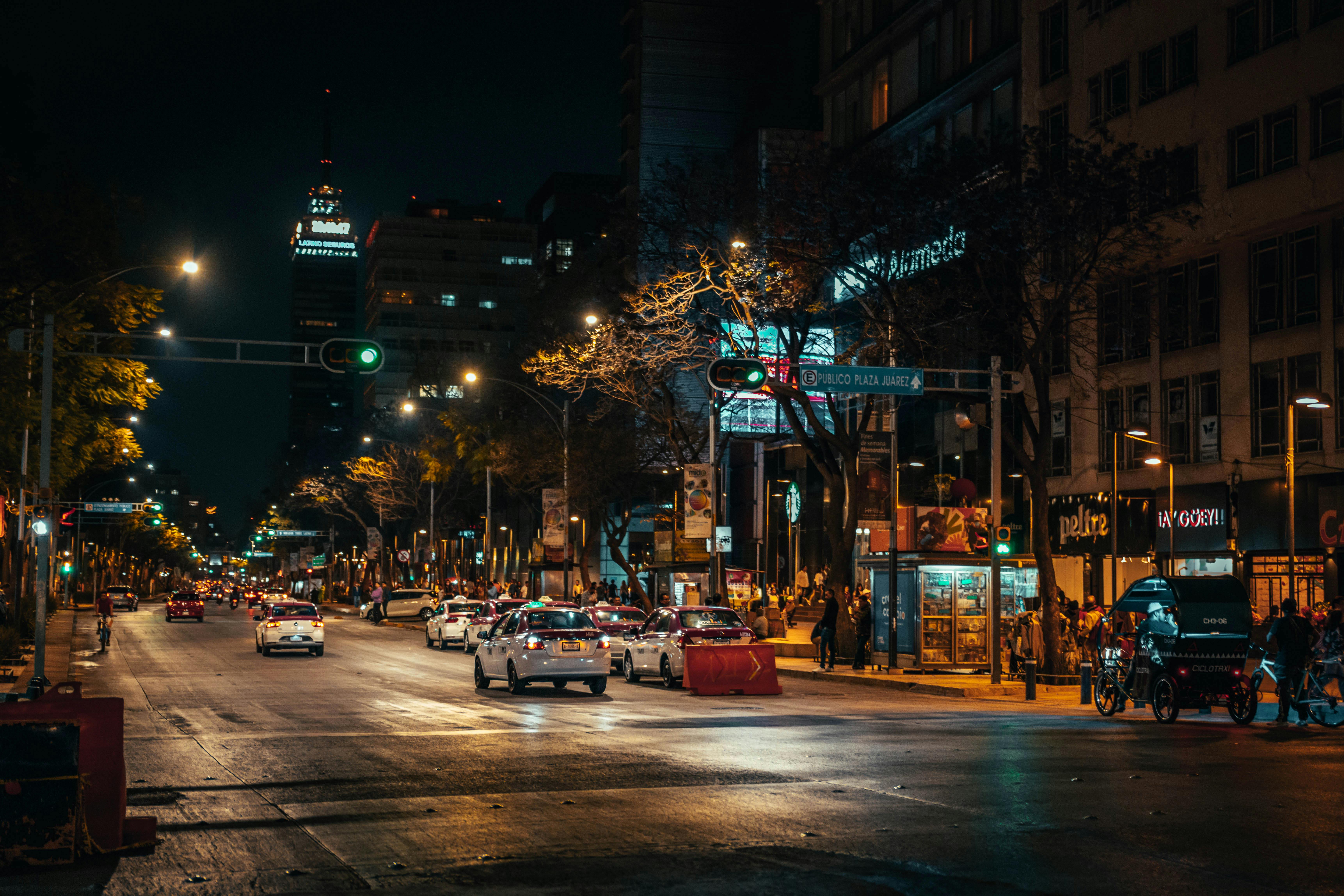 a city street at night with cars and lights