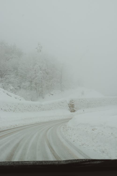 Road during a Heavy Snowfall Photographed from the Inside of a Car 