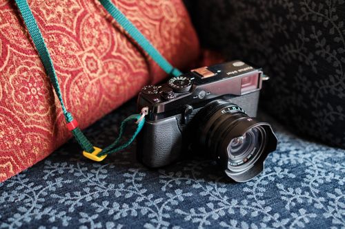 Free Close-up of a vintage camera on textured cushions, ideal for photography enthusiasts. Stock Photo