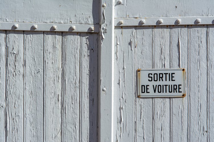 Board With Text In French On White Wall