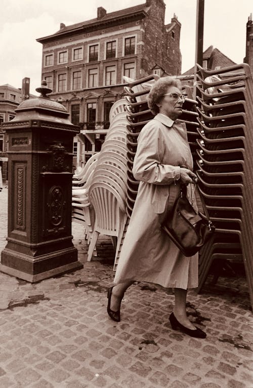 Woman in Coat Walking in Town