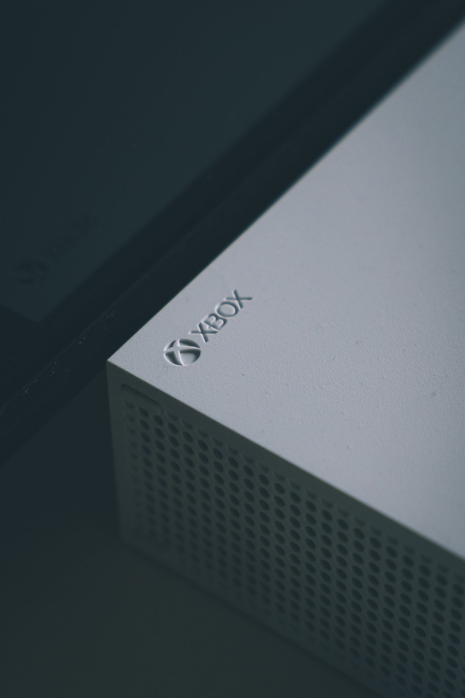 Close-up of an Xbox gaming console highlighting the Xbox logo, a real stock photo with no people and no controller in the frame, chosen to evoke the Xbox brand behind the Nano Controller story