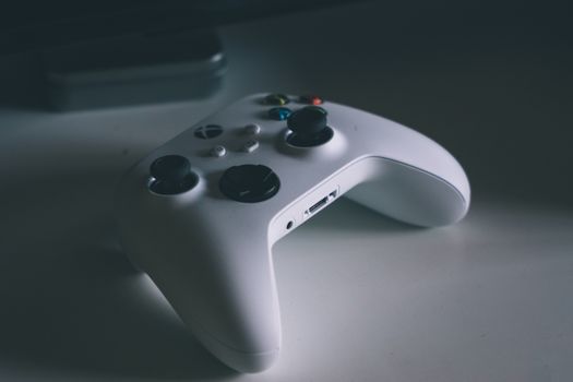 A detailed shot of a white gaming controller on a desk surface, perfect for tech and gaming themes.
