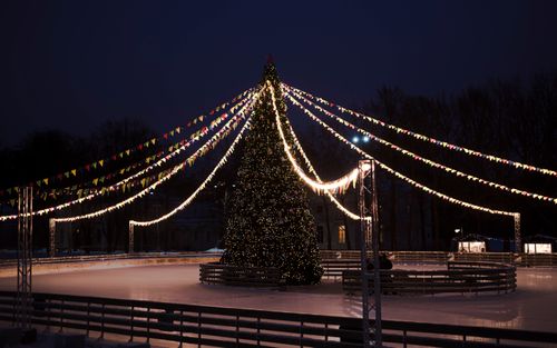Free Beautifully decorated Christmas tree with lights in a city skating rink at night. Stock Photo