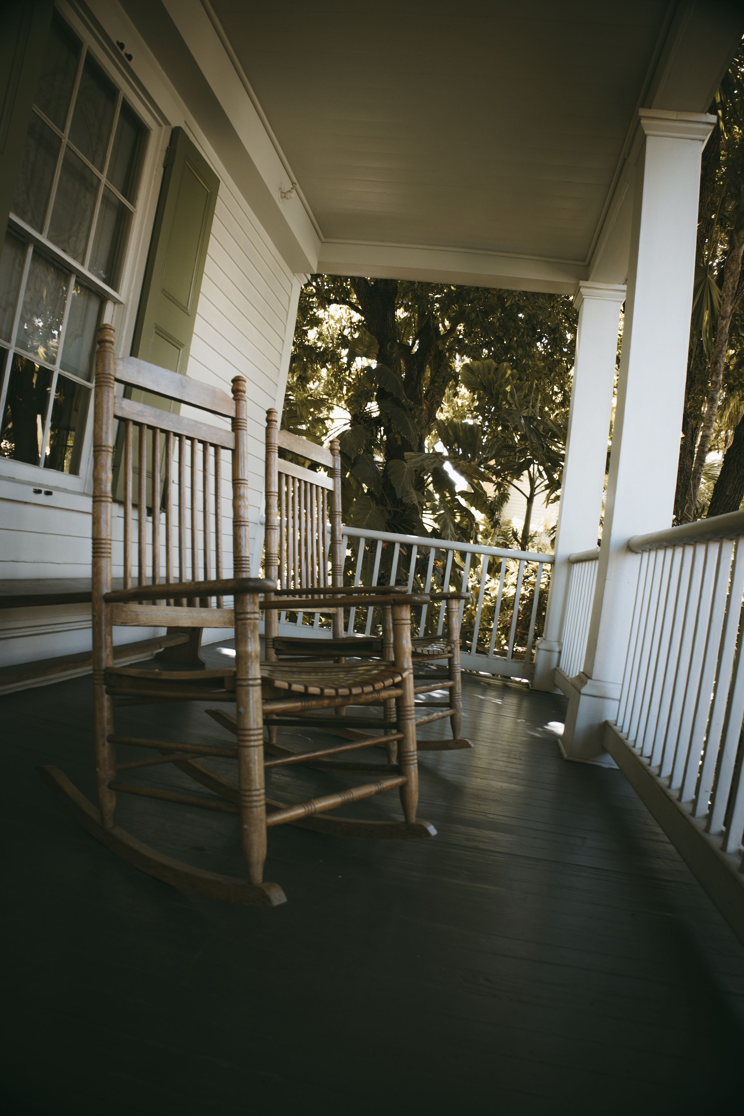 Rocking chairs on a quiet porch at dusk
