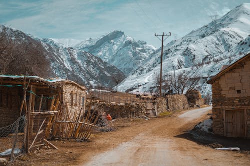 View Snowcapped Mountains from a Village in the Valley 