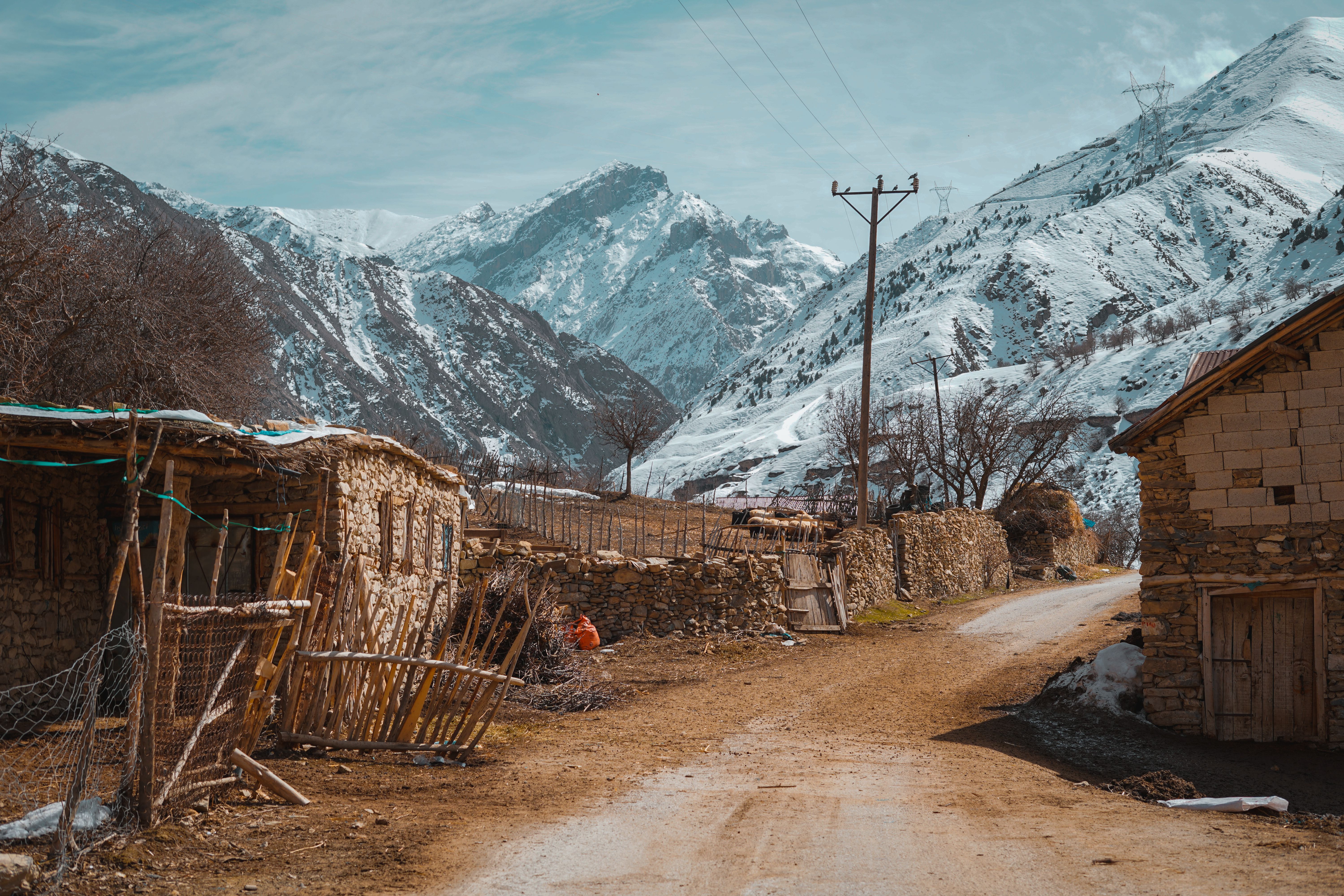 View Snowcapped Mountains from a Village in the Valley · Free Stock Photo