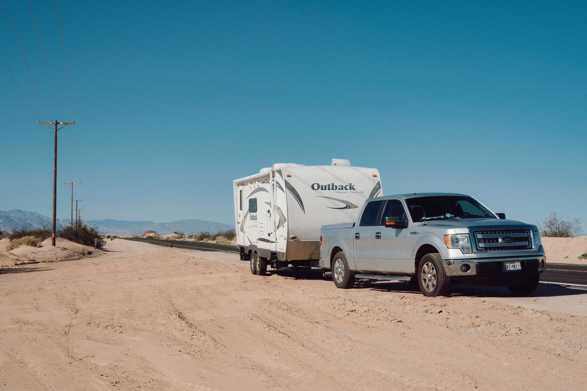Truck towing a camper trailer directly illustrates the sustained towing scenario described in the section.