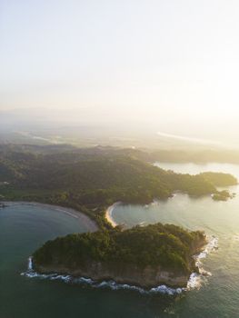 Stunning aerial view of the lush Costa Rican peninsula at sunset, capturing the tranquil sea and scenic coast.